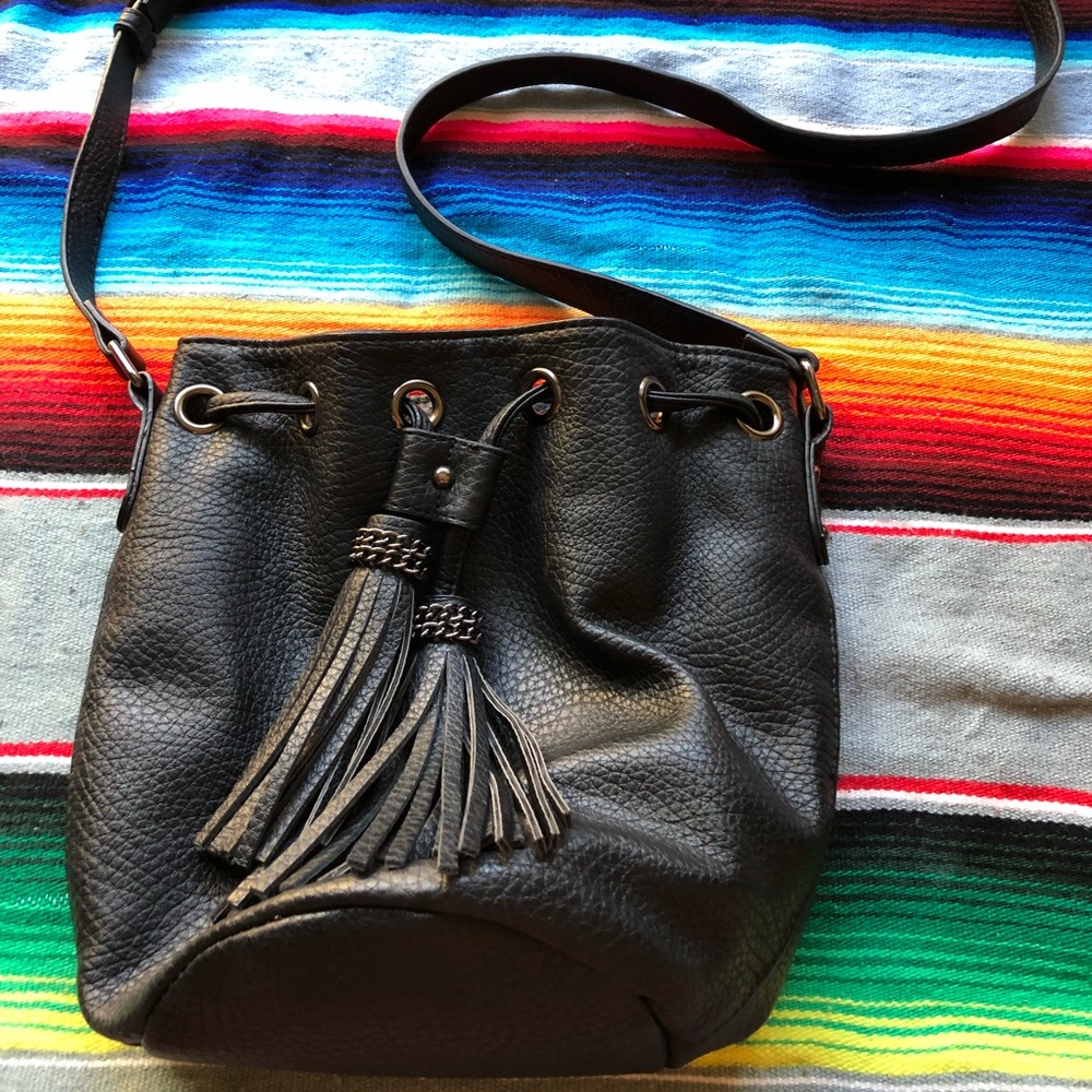 Black bucket bag with tassels.